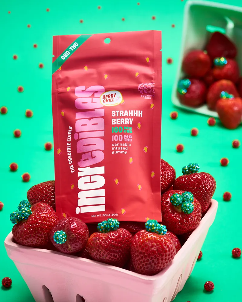 incredibles Strahhhberry gummies pouch in a basket of strawberries