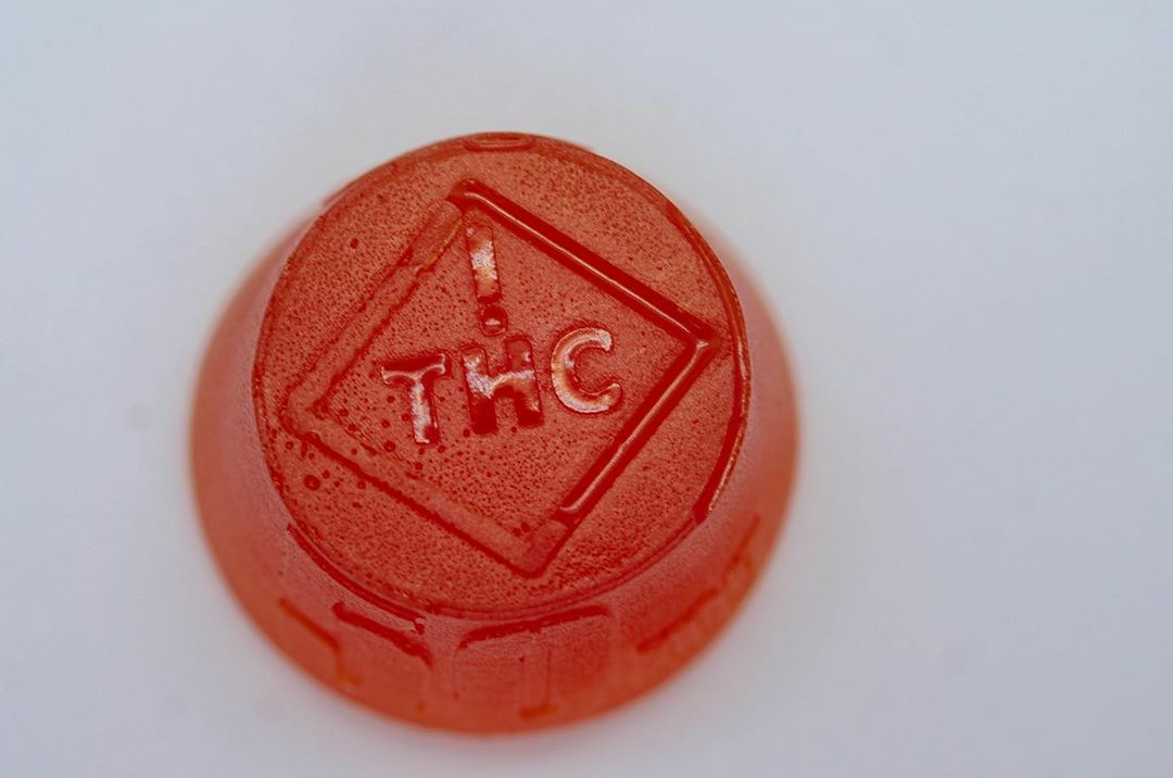 A large, red incredibles cannabis-infused medical gummy. Start low and go slow to avoid a cannabis overdose.
