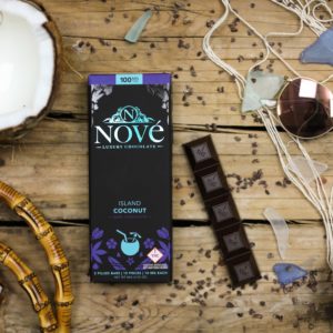 Nove Island Coconut luxury cannabis chocolates surrounded by island-themed props. This is a cannabis product for summer!