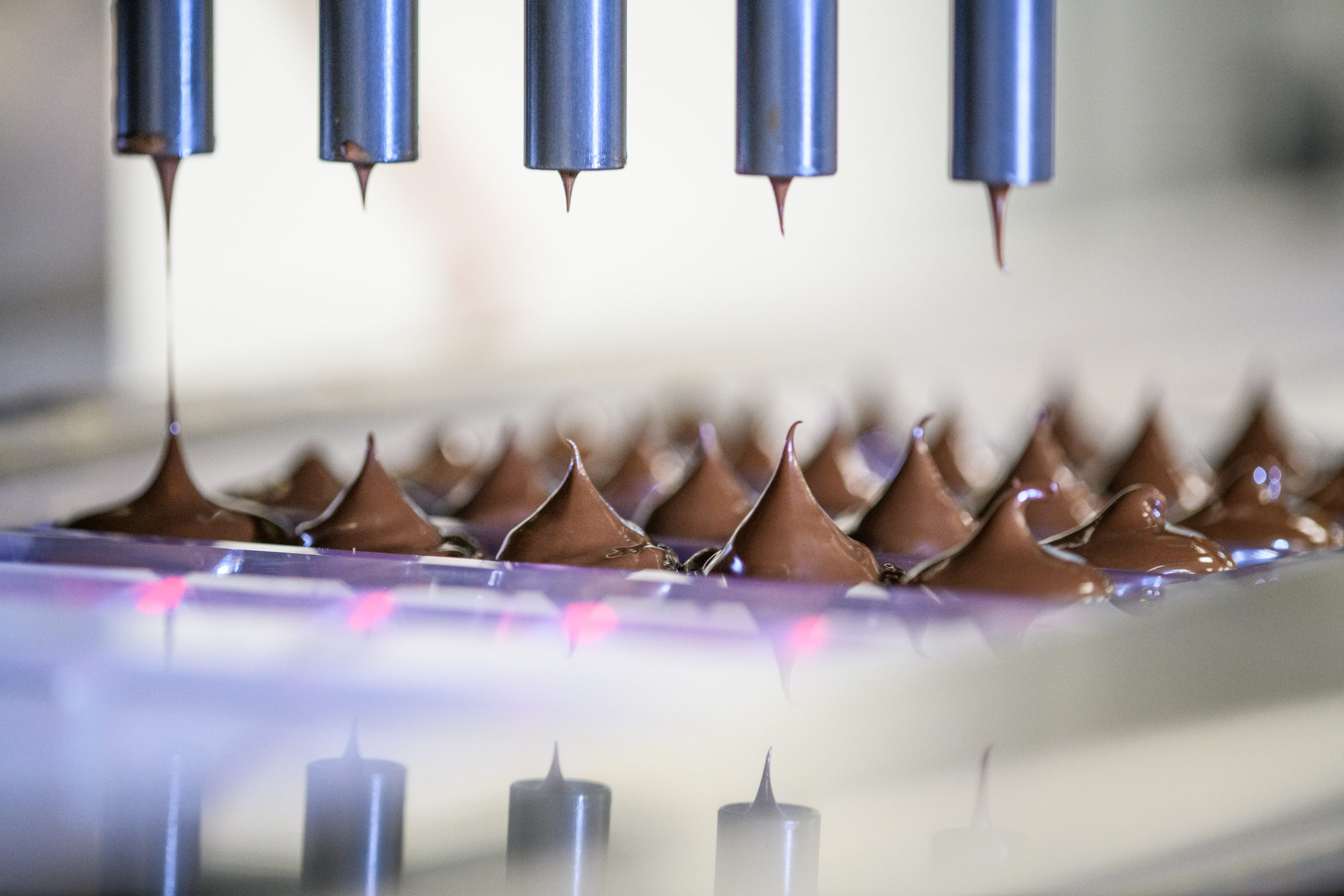 Production of Nove Luxury Chocolates; chocolates being dispensed into a mold.